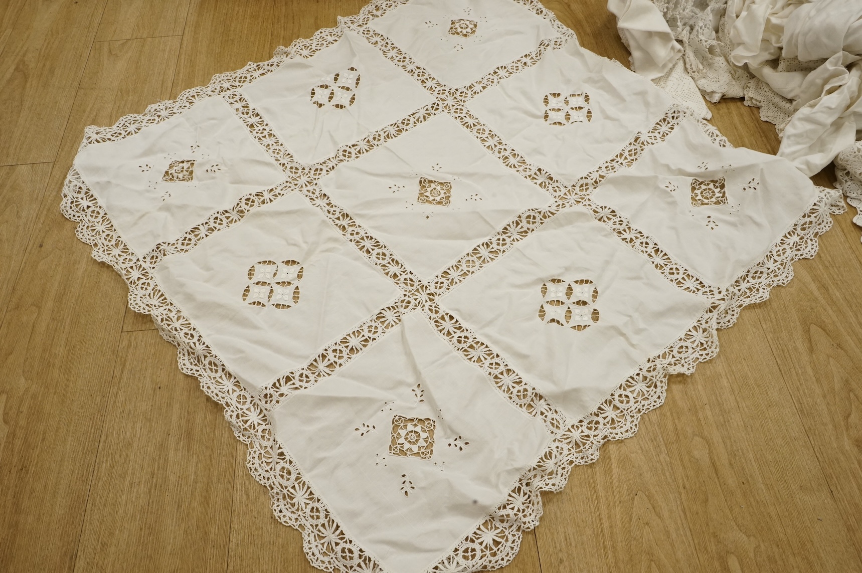 A collection of crochet, embroidered and damask linen table cloths and napkins